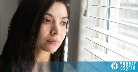 Foreign woman stares out window